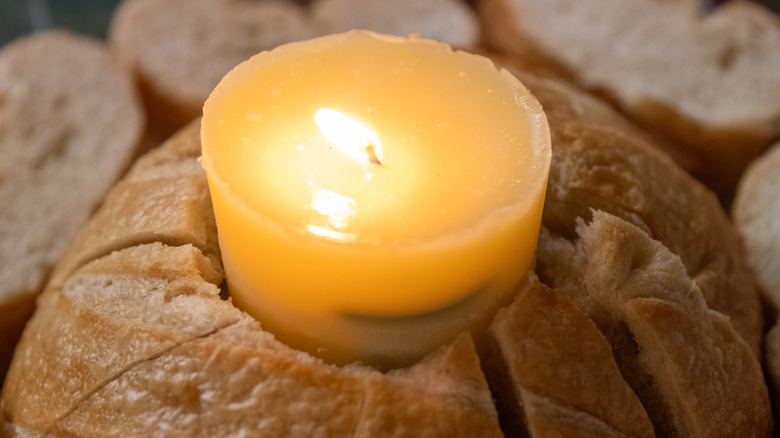 a garlic butter candle in a loaf of bread