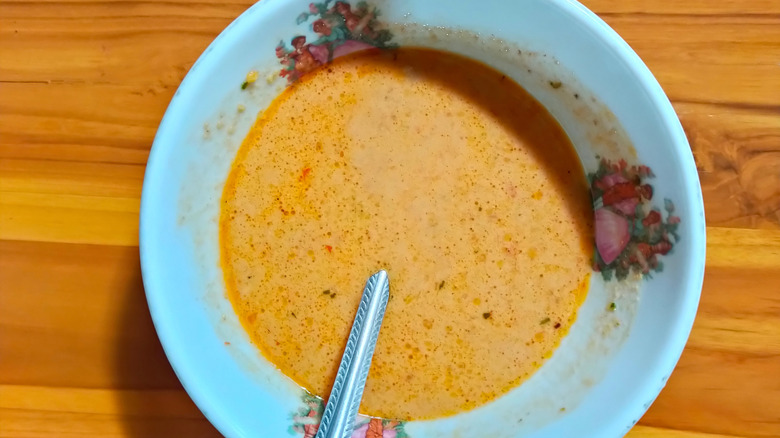 Spicy peanut sauce in a bowl with a spoon