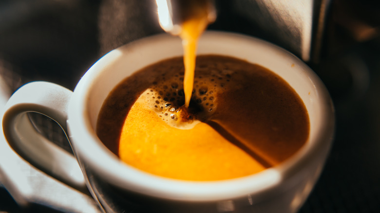 coffee machine pouring into a mug
