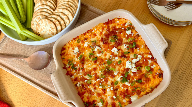 Buffalo chicken dip with crackers and celery