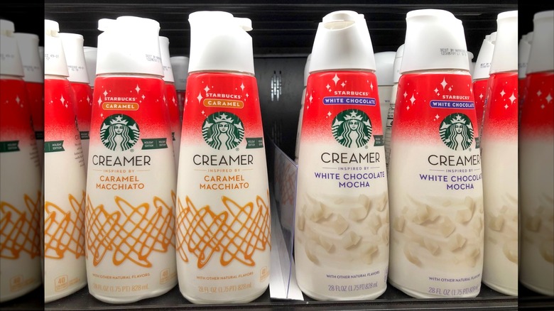 Bottles of Starbucks caramel and white chocolate mocha coffee creamer at a grocery store