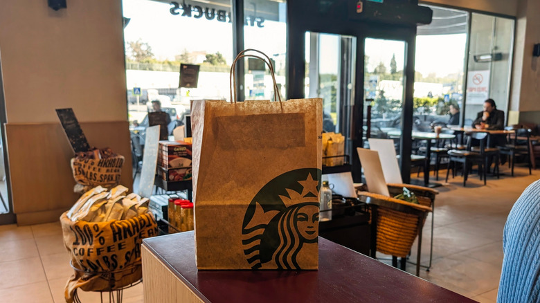 A Starbucks order in a brown takeaway bag
