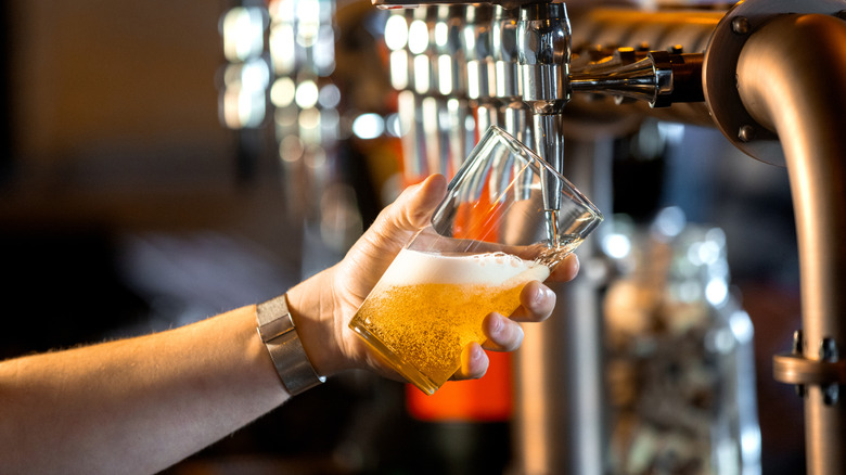 Beer glass being filled from tap
