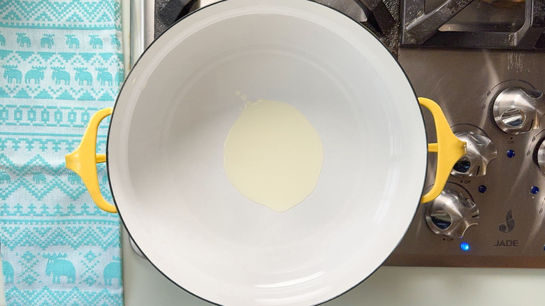 Avocado oil heating in pot on stove