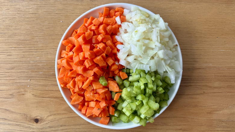 chopped carrots, celery, and onions on a white plate