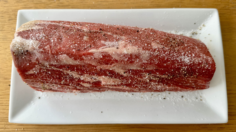 beef tenderloin on plate seasoned with salt and pepper