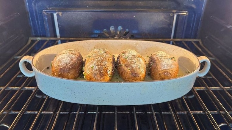Hasselback potatoes in baking dish in oven