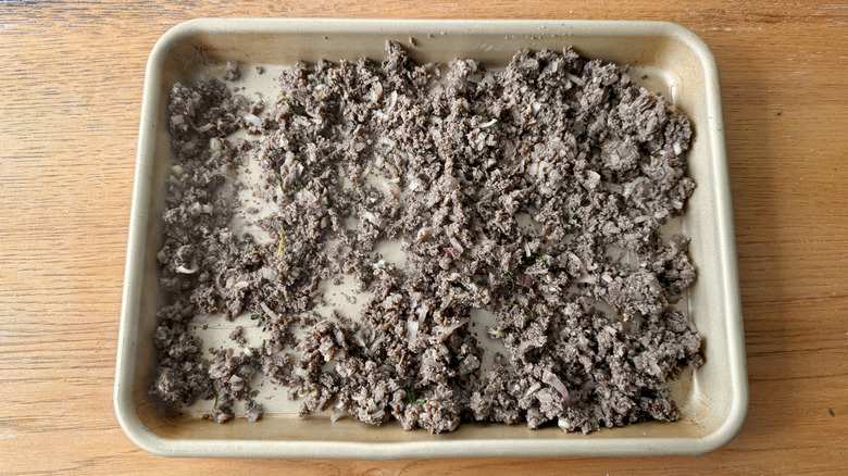 cooked mushrooms cooling on baking sheet