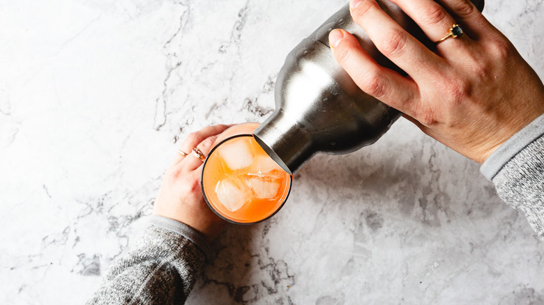 pouring drink into glass