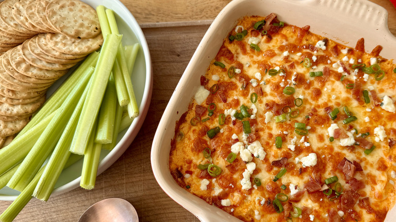 Crackers, celery sticks, and Buffalo dip