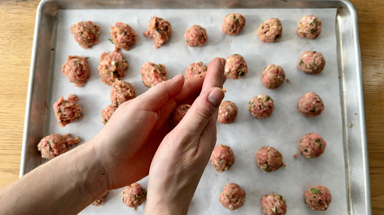 hands rolling a meatball