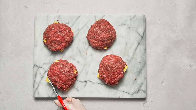 trimming cheese from patties
