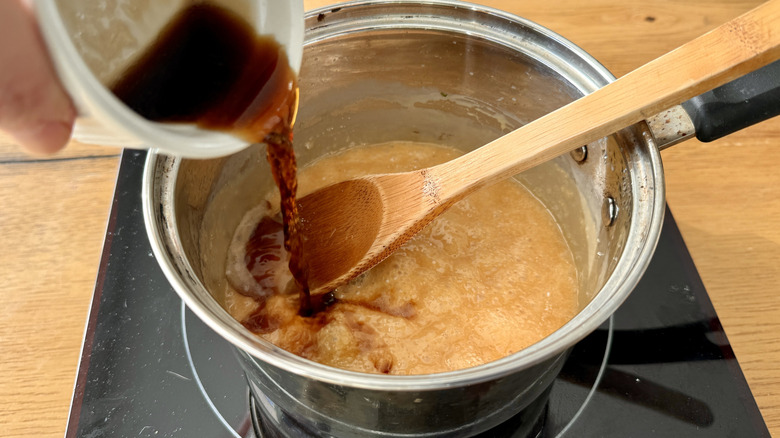 Pouring stout into caramel in saucepan