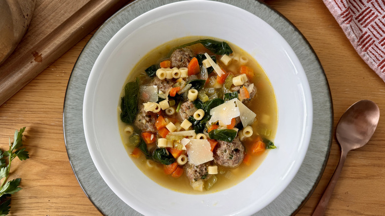 vegetable, meatball, and pasta soup in white bowl