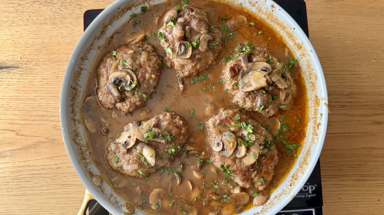 Parsley sprinkled over Salisbury steaks