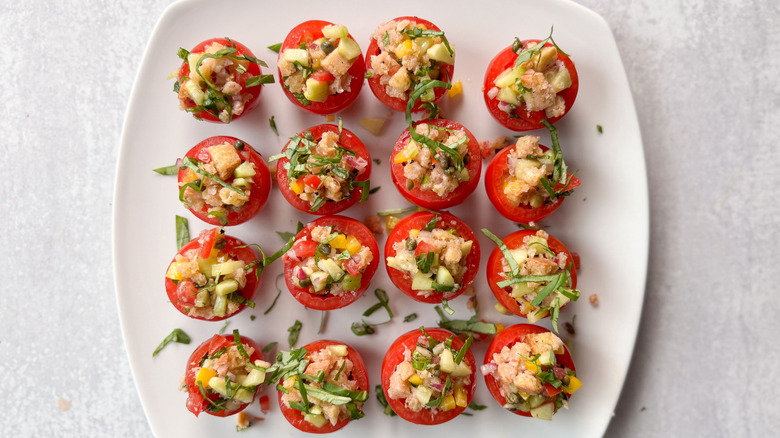 Bite-sized panzanella stuffed tomatoes on plate