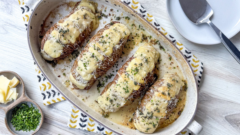 Extra cheesy Hasselback potatoes in serving dish