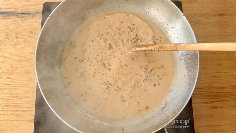simmering creamy mustard sauce in skillet