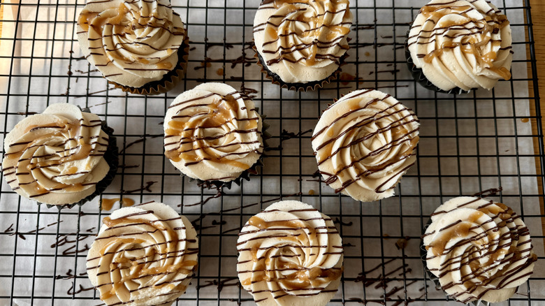Frosted cupcakes drizzled with caramel and chocolate