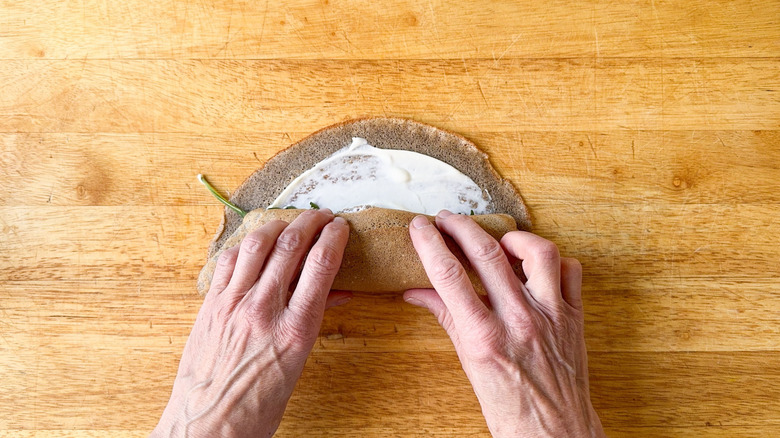 Rolling up filled buckwheat crepe