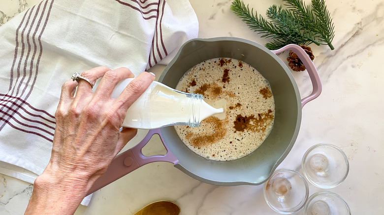 adding milk to pot
