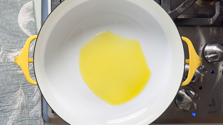 Olive oil heating in pan on stovetop