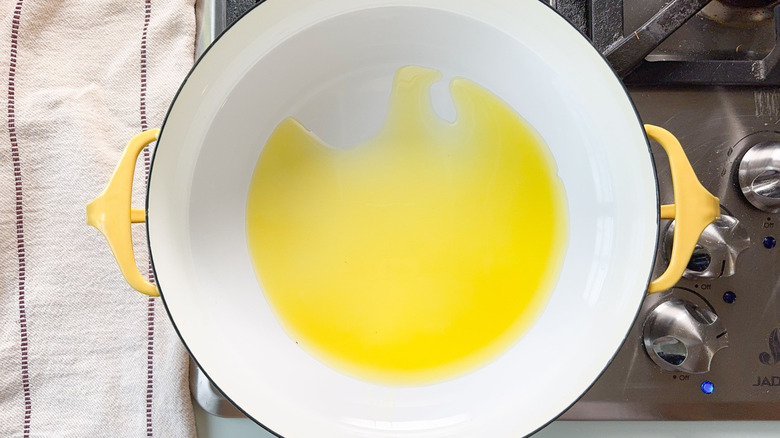 Olive oil heating in pot on stovetop