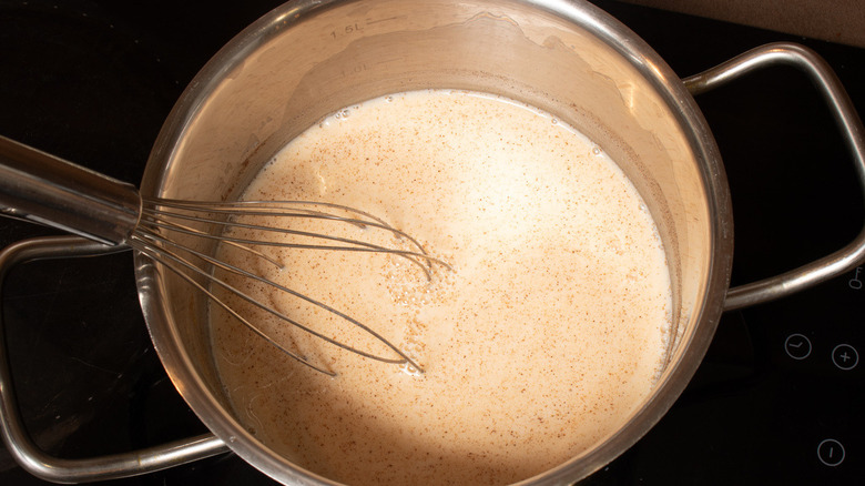 tan liquid in metal pot