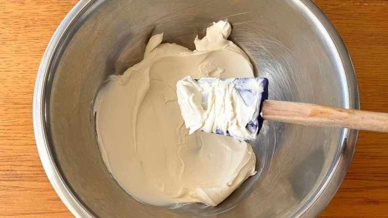 Softened cream cheese in bowl with spatula