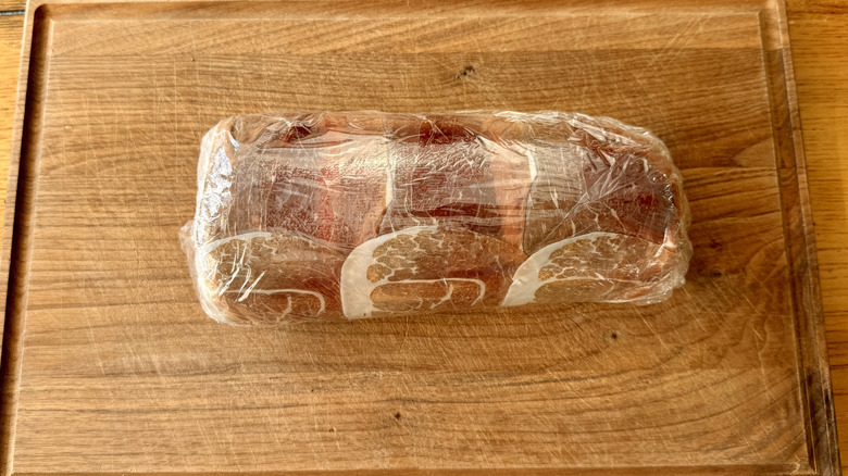 tightly wrapped tenderloin on wooden surface
