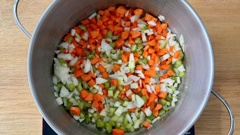chopped carrots, celery, and onions in a metal pot