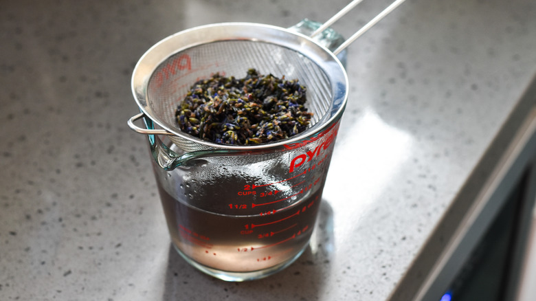 lavender flower syrup in strainer