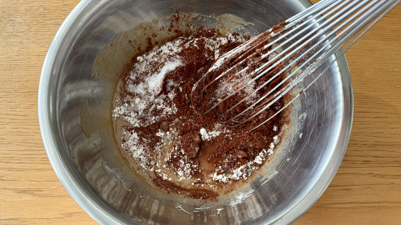 Whisking dry ingredients into wet ingredients in bowl