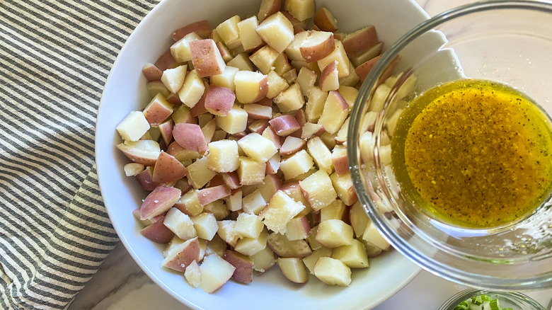 adding dressing to potatoes