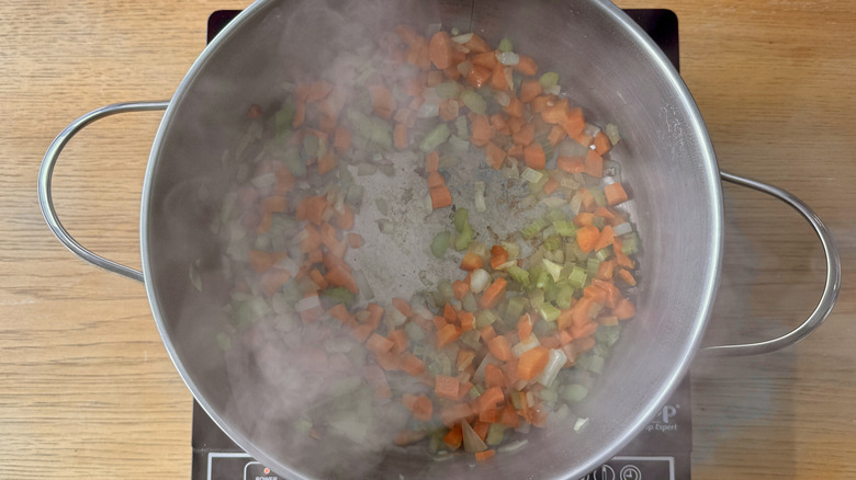 chopped carrots, celery, and onions in a metal pot