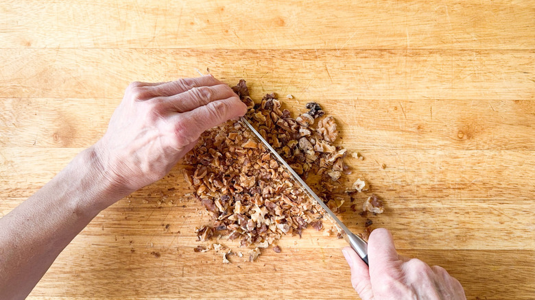 Chopping walnuts on cutting board