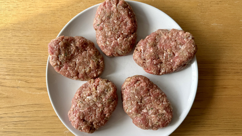 Raw Salisbury steaks on plate