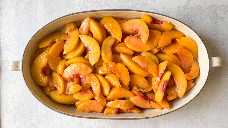 Sliced peaches in oval baking dish