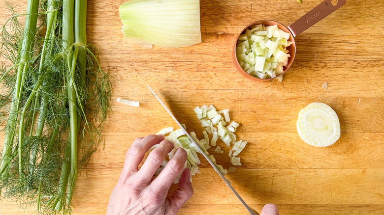 Chopping fennel bulb on cutting board