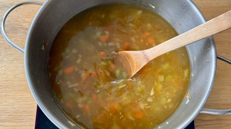 vegetables and broth in a metal pot