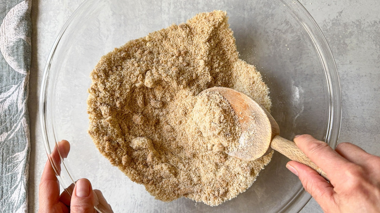 Cobbler dry ingredients in glass bowl with wooden spoon