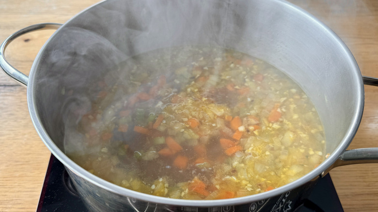 vegetables and broth in a metal pot