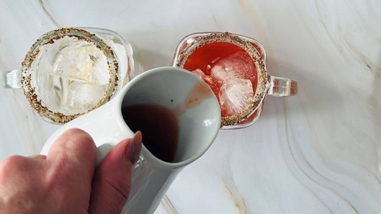 pouring tomato juice in glass