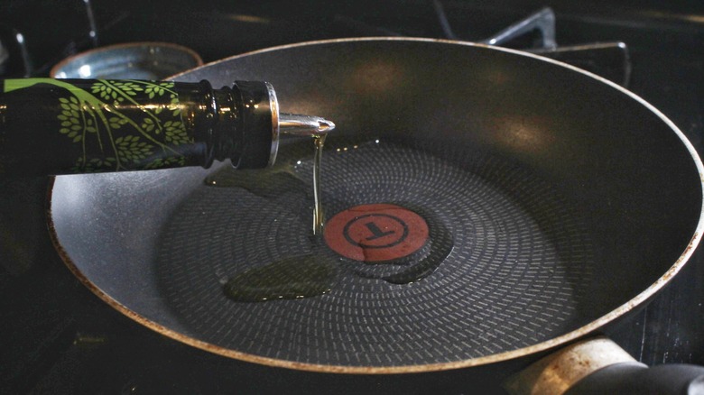 oil pouring into skillet