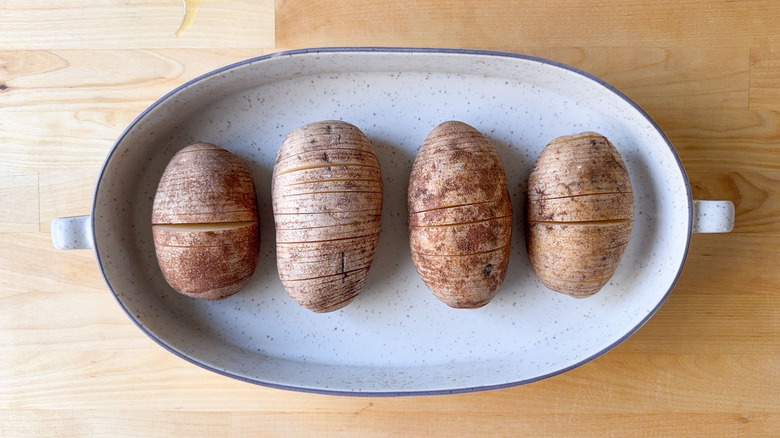 Sliced Hasselback potatoes in baking dish