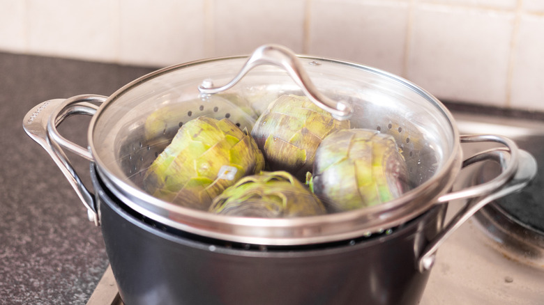 artichokes in lidded steamer on stove