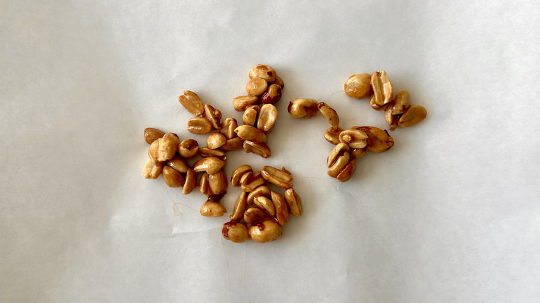Candied peanuts cooling on parchment