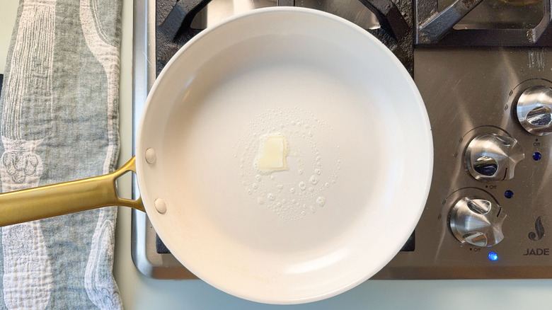 Crepe pan with butter melting on stovetop