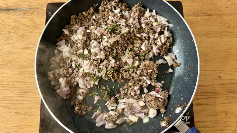 mushrooms, garlic, and shallots sauteeing in skillet