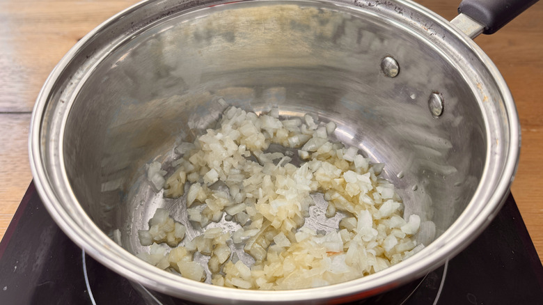 oil and onions in a metal pot